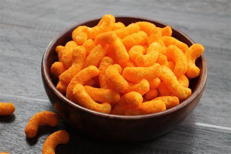 A bowl of cheese curls on the table